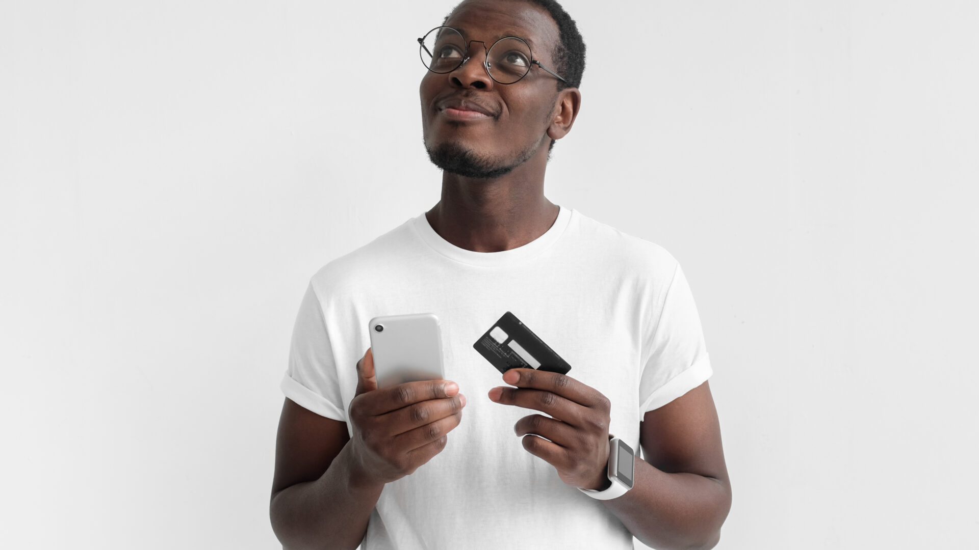 Gentleman holding a credit card and his phone.