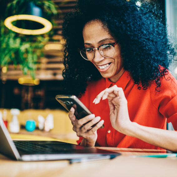 African-American female scrolling on her phone.