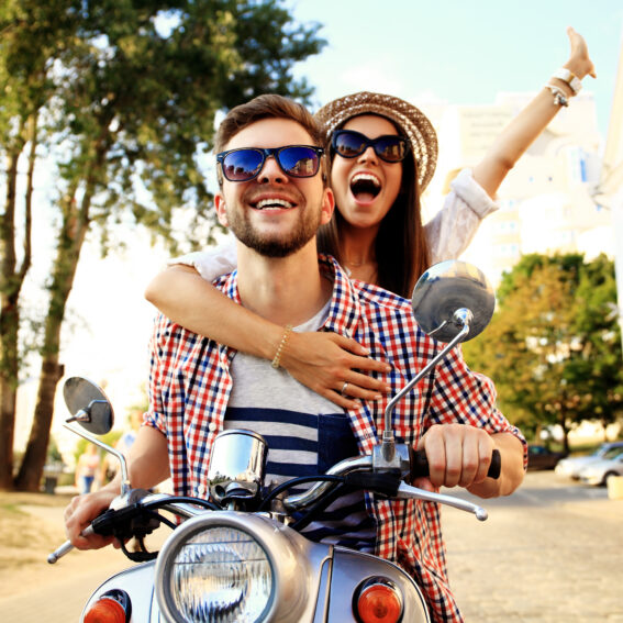 Happy couple exploring on motorcycle.