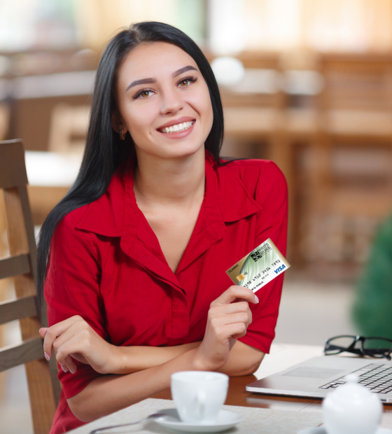 Young women holding a credit card.
